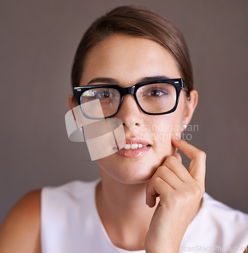 Image of Portrait, studio and woman thinking with glasses for vision, eyesight and professional employee. Worker, smile and female person contemplating career in corporate company in New York for startup