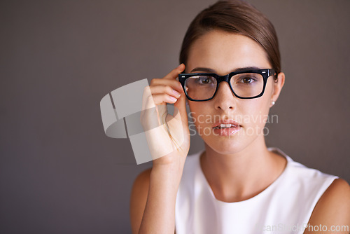 Image of Portrait, business and glasses with woman, optometry and employee on a studio background. Face, person and model with stylish eyewear or clear vision with mockup space and frame with sight or agent