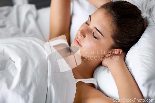 Image of Bedroom, sleep and closeup of woman in bed at house, home and hotel to relax, rest and wake up refreshed in Cape Town. Female person, lady and tired with pillow, blanket and comfortable in nap