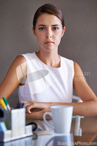 Image of Portrait, business woman and confident at office desk, arms crossed and ambition in corporate career. Young hr administrator, face and relax in workplace by coffee, stationery and commitment in job