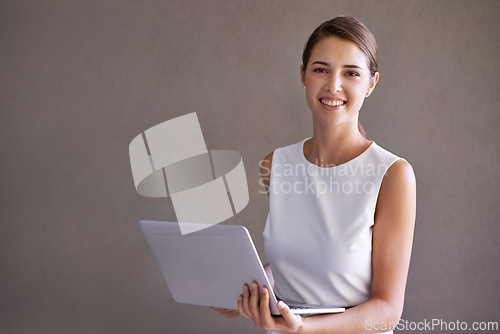 Image of Business, portrait and woman with laptop, smile and entrepreneur on a studio background. Person, connection or PR consultant with a computer or internet with website information, tech or confidence