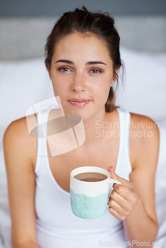 Image of Woman, coffee and portrait in bed for tired in morning for wakeup and drink in cup for warm and strong with milk. Young person with beverage for caffeine on weekend for boost in mug with pajamas