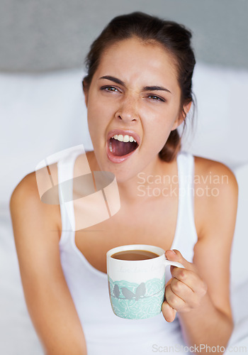 Image of Woman, tired and yawning with coffee in bed, waking up from sleeping or nap with morning routine at home. Insomnia, fatigue and sleepy in bedroom, warm drink or beverage for breakfast and start day