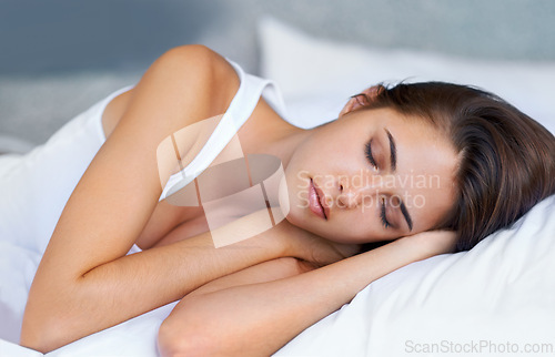 Image of Bedroom, morning and woman sleeping in bed at house, home and hotel to relax, rest and wake up refreshed in Cape Town. Female person, lady and tired with pillow, blanket and comfortable in nap