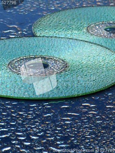 Image of CD and water drops over blue background