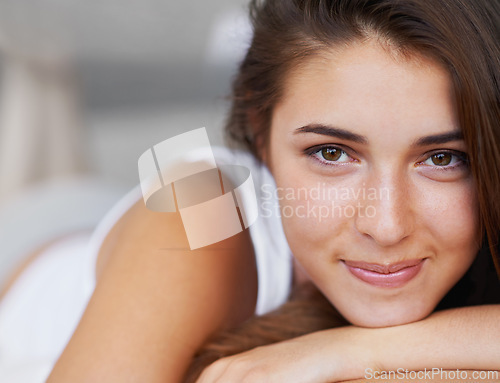 Image of Portrait, face and woman with smile in bedroom, wellness and wake up from healthy sleep on bed. Morning, girl and female person with happiness to relax with peace, lazy and rest in apartment