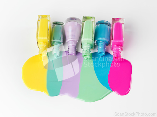 Image of Nail, polish or bottle to spill in cosmetic, beauty or product art as playful, manicure or pedicure. Creative aesthetic, cosmetology or color paint pattern as liquid, drip or flow on white background