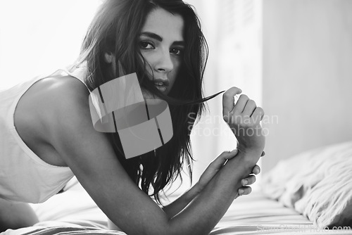 Image of Portrait, black and white with woman, bed and relaxing with confidence and home with beauty. Face, person and bedroom with girl and monochrome with rest and leisure with style and casual outfit