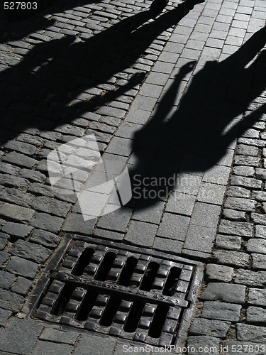 Image of Shadows of people on street