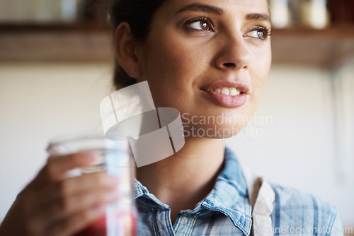 Image of Woman, glass and juice with kitchen, closeup and person with smoothie for health or wellness. Nutritionist, drink and beverage for nutrition, vitamins and vitality for juicing diet with apron at home