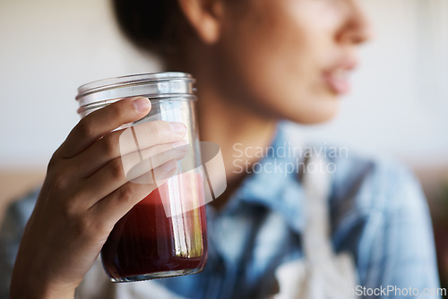 Image of Glass, hand and smoothie with woman in kitchen of home closeup for diet, health or nutrition. Detox, juice for weight loss and person in apartment with fresh fruit beverage for minerals or vitamins