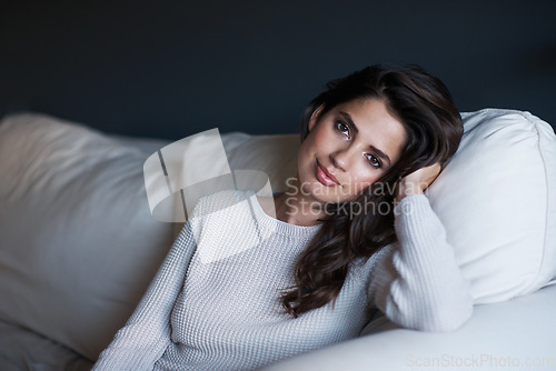 Image of Portrait, woman and couch with break, confidence and style with lounge or sofa. Person, sweater and proud with elegant, relaxation and rest with youth and face in living room at house or home