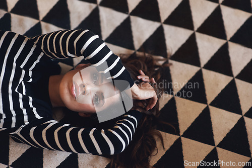 Image of Portrait, woman or lying on carpet in fashion, couture and clothing for minimalist style aesthetic. Edgy, female person and trendy as texture, pattern and design of contemporary fabric and textile