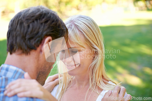 Image of Love, smile and couple hug in a park with trust, care and support, security or solidarity outdoor. Smile, romance and people embrace in forest with fresh air, commitment or peaceful vacation trip