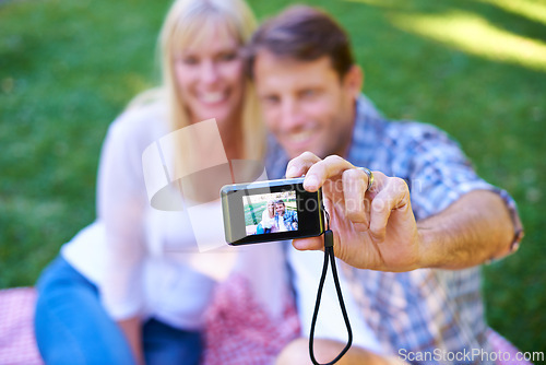 Image of Camera, screen and couple in a park, date and happiness with love and romance with a selfie in nature. Photograph, outdoor and memory with man and woman with marriage and relationship with sunshine