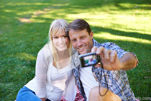 Image of Selfie, camera and couple in a park, love and happiness with marriage and romance with summer or nature. Photograph, outdoor or memory with man or woman with relationship, relax or date with sunshine