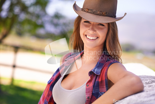 Image of Cowgirl or woman, happy and portrait outdoors in rural or countryside for agriculture, adventure and nature in summer. Female cowboy, farm or ranch in Western Texas for sustainability with wellness.