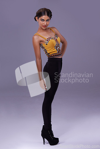 Image of Portrait, fashion or woman in studio with heels, clothes or confidence for Spanish style or pride. Creative model, purple background or artist with trendy clothing, contemporary or modern aesthetics