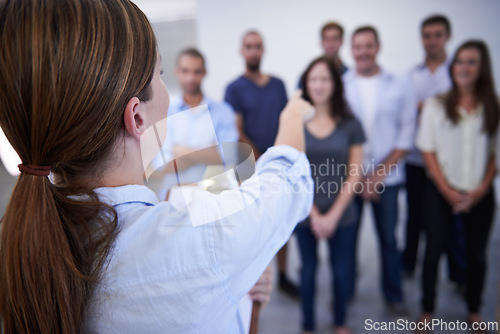 Image of Woman, office and point at people for decision on training at work, back view and clipboard with notes. Female person, diverse group and supervisor in startup business, company and job interview