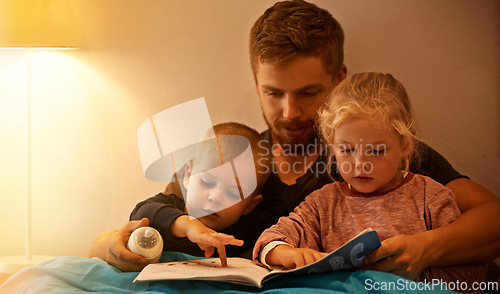 Image of Night, kids or dad reading book in bed for learning, education or storytelling in a home for care. Family, relax or father with children siblings for a fantasy with a girl, boy or support for love