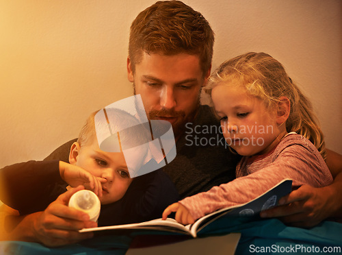 Image of Night, kids or father reading book in home for learning, education or storytelling in a house for care. Family, relax or dad with children siblings for a fantasy with a girl, boy or support for love