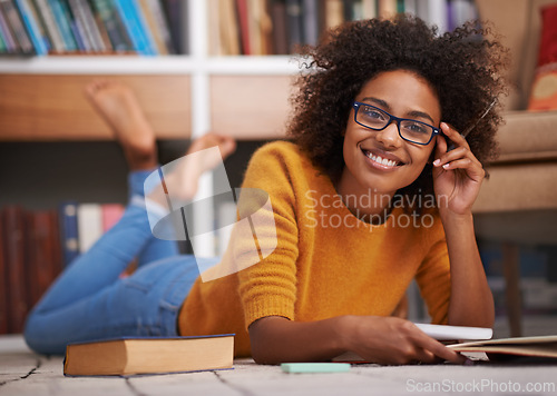Image of Portrait, floor and African woman in library, smile and study for education. Textbooks, paper and glasses material for happy female student with natural afro hair, learning and notes for knowledge