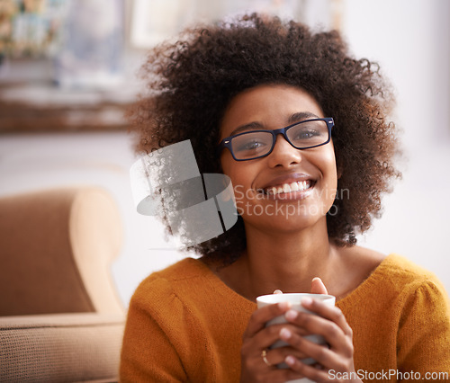 Image of Portrait, coffee and happy woman in home lounge, smile and eyewear for relax person. Apartment, comfort and calm with tea or hot beverage, me time and peace in living room and positive aesthetic