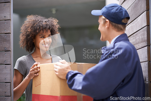 Image of Courier, home and delivery box with woman and package with a smile from shipping order. House, happy and shipment with man giving a cardboard parcel from moving company with distribution service