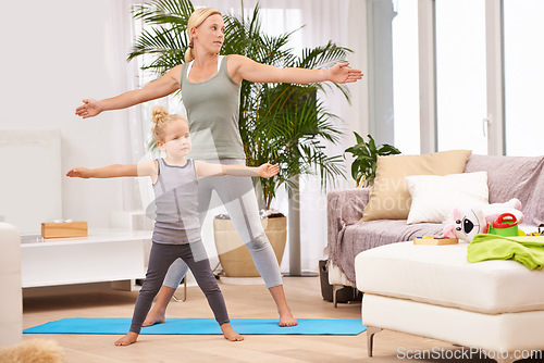 Image of Yoga, exercise with mother and daughter in living room, stretching out arms for balance and bonding. Woman, young girl and fitness together at family home, health and wellness with love and care