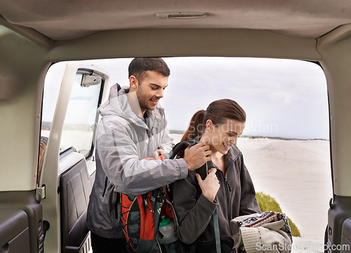 Image of Jeep, man and woman outdoors for backpacking on vacation for adventure or travel, active and gear for road trip. Male, female explorers, tourists and car for camping and trekking, journey and nature.