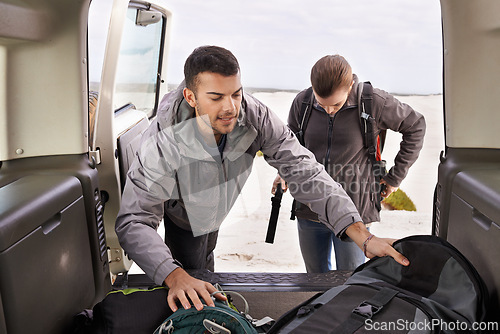 Image of Car, man and woman outdoors for backpacking on vacation for adventure or travel, active and gear for road trip. Male, female explorers, tourists and jeep for camping and trekking, journey and nature.