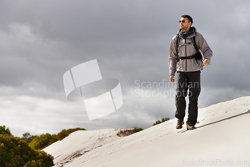 Image of Travel, fitness or man in desert with backpack for adventure, journey or resort, location or explore. Freedom, holiday or male backpacker in Egypt for sand dunes walking, wellness or hiking in nature
