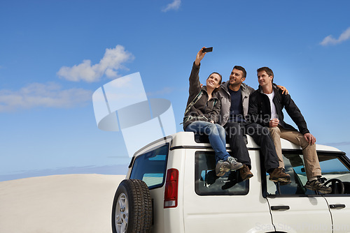 Image of Friends, car and selfie in desert with smartphone with smile for adventure, holiday and road trip to travel. People, happy excited in sand dunes for vacation or break with bonding for memory