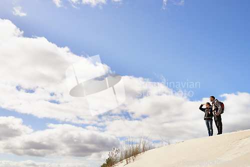 Image of Travel, love and couple in desert for location search, view or scenery while bonding in nature. Freedom, adventure or people in sand dunes for journey, hiking or wellness, backpacking or fun in Egypt