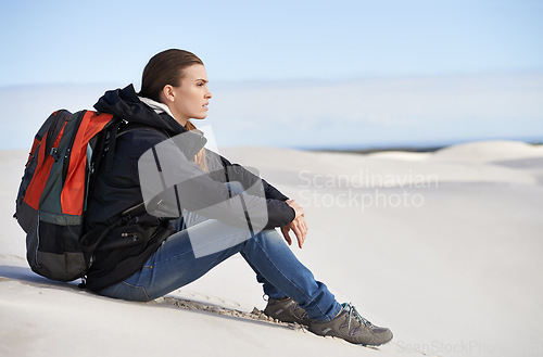 Image of Hiking, sand dunes or woman in nature to relax for adventure, desert landscape and travel for holiday. Break, thinking or nomad explorer in Sahara terrain, outdoor and dry climate for view or scenery