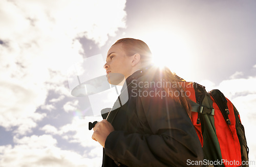 Image of Woman, hiking and walking by blue sky for fitness adventure in nature and extreme sport in hot sunlight. Athlete, below and survival gear for environmental exploration, travel and trekking in oman