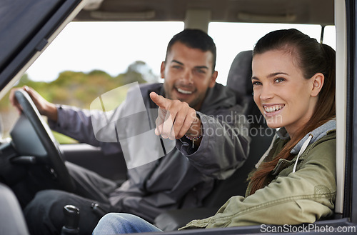 Image of Couple, car and pointing on roadtrip with travel for adventure, vacation or sightseeing with happiness in countryside. Woman, man or driving in vehicle for holiday journey, tourism and honeymoon trip