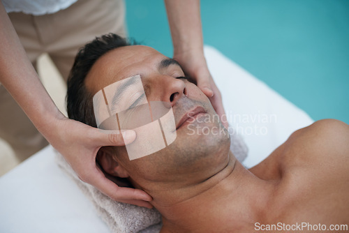 Image of Outdoor, spa and man relax for facial massage on table in hotel, calm and care for body in vacation. Holiday, luxury and male person on break for weekend, resort and lodge with treatment for skincare