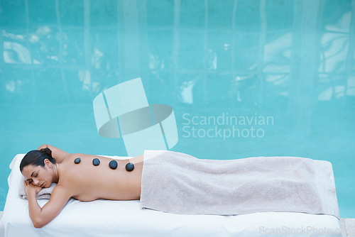 Image of Spa, hot stone massage and woman at pool at hotel for health, zen wellness and luxury holistic treatment. Self care, relax or girl on table for body therapy, comfort and calm pamper service in mockup