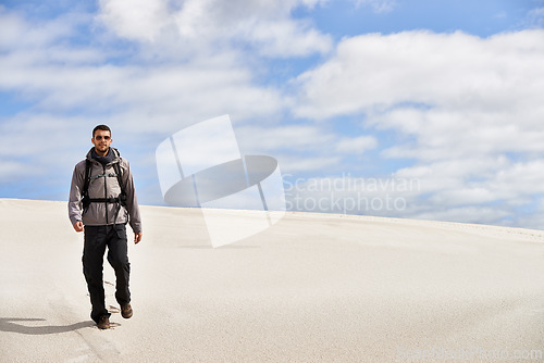 Image of Travel, backpack or fitness man in desert for adventure, journey or resort, location and exploration. Freedom, holiday or male backpacker in Egypt for sand dunes walking, wellness or hiking in nature