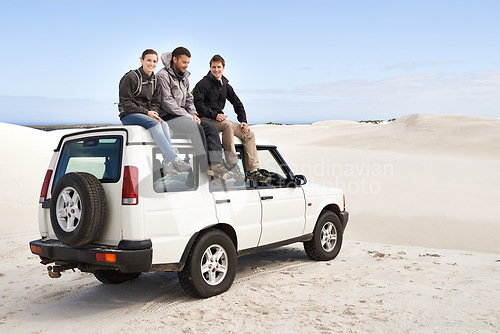 Image of Car, adventure and friends sitting on roof for road trip break, travel and off road drive in sand dune. Relax, transportation and people in nature for getaway, summer vacation and journey in Mexico