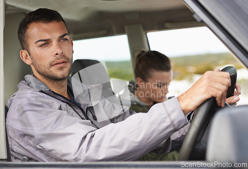 Image of Couple, car and driving on roadtrip with travel for adventure, vacation and concentration of driver in countryside. Woman, man and serious in transport for holiday journey, tourism and honeymoon trip