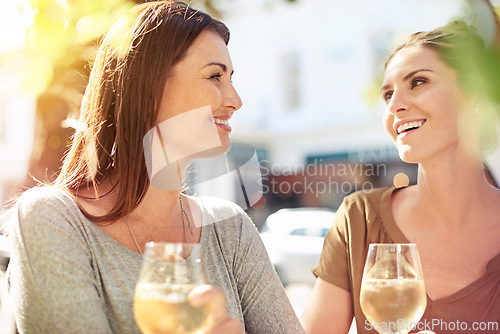 Image of Friends, relax and happy at restaurant with wine to drink on holiday or vacation date together. People, smile and enjoy glass of chardonnay, alcohol or champagne outdoor at cafe at dinner in city