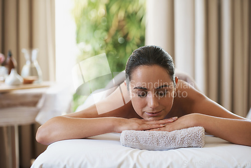 Image of Spa, treatment and smile for woman on massage table, salon and beauty therapist in wellness centre. Peaceful, zen and physical therapy for body and relax, pamper and skin care for sleeping client