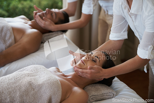Image of Vacation, facial massage and couple relax in spa for care of body with rest on table of retreat for honeymoon. Hotel, man and woman together in resort for health, wellness and holiday for skincare