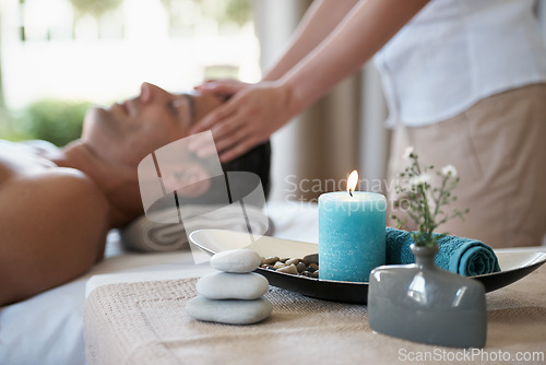 Image of Luxury, facial massage and man relax in spa with aromatherapy candle for holistic treatment. Hotel, peace and health for male person, wellness and rest in resort for holiday for skincare in break