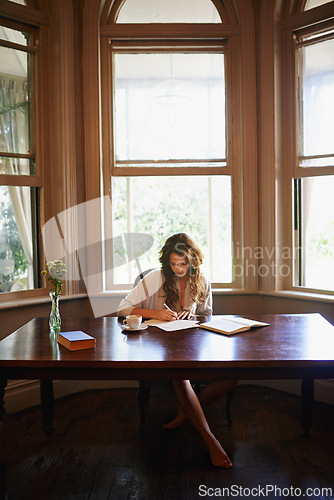 Image of Remote work, books and woman writing in home office for idea inspiration, checklist or planner. Freelance, creative and female writer with pen for novel notes, reminder or planning business startup