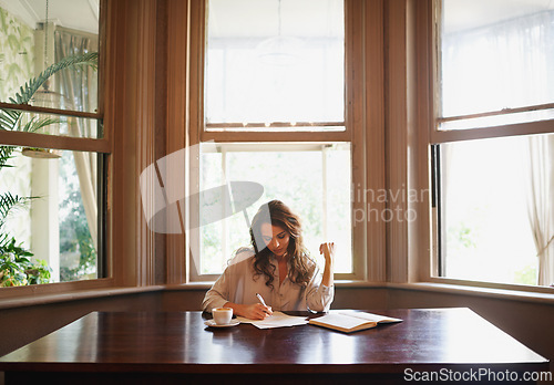 Image of Books, remote work and woman writing in home office for idea inspiration, checklist or planner. Freelance, creative and female writer with pen for novel notes, reminder or planning business startup