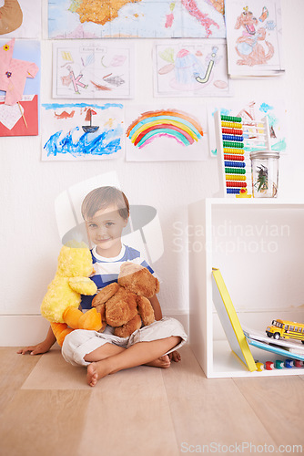 Image of Child, toy and portrait with teddy, smile and happiness for fun and joy at home or daycare. Boy, play and positive with stuffed animal, laugh and childcare for growth and cheerful on wood floor