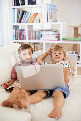 Image of Laptop, smile and kids on sofa in home to relax, learning and family streaming cartoon on internet together. Computer, children and boys in living room for education, movies or brothers with games